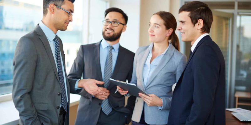 Confident businesspeople listening to their partner explaining his idea